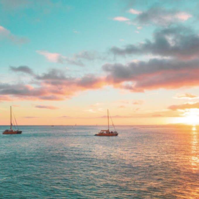 Sunset in the Bahama with two catamarans moored