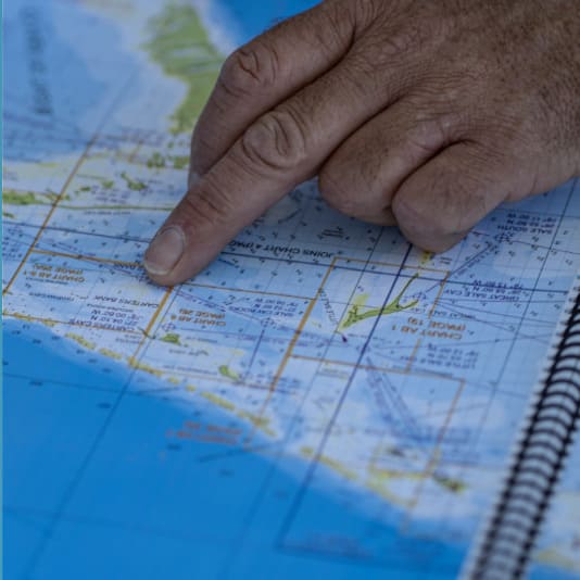 Close up of a hand on a nautical navigation chart