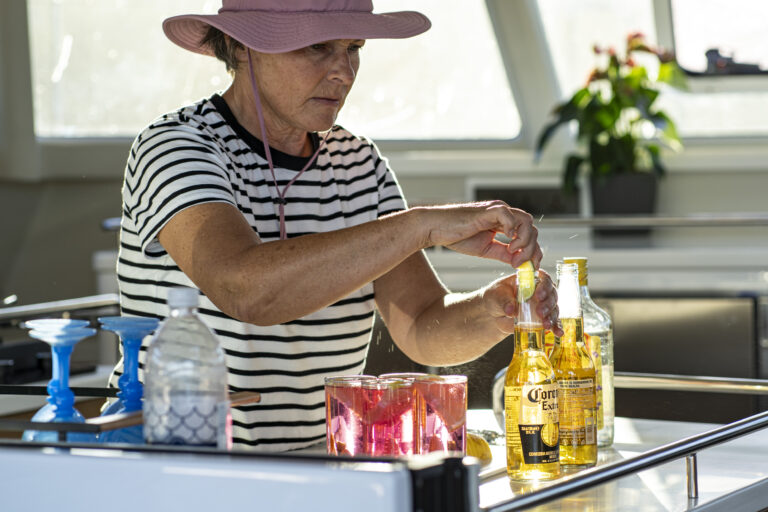 woman preparig drinks in the galley of a catamaram