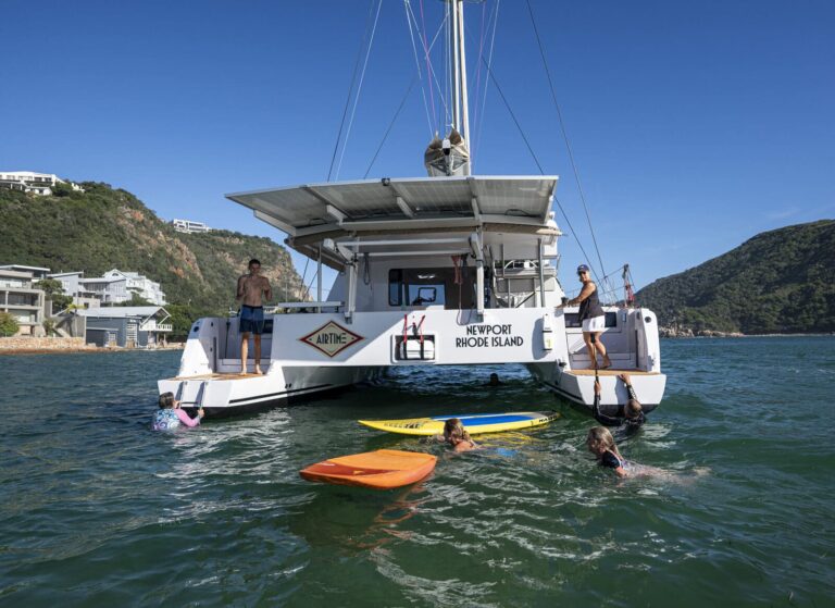 Catamaran towing a paddle board